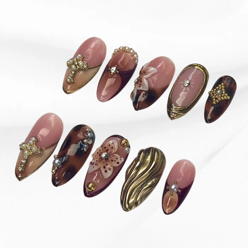 Glam Tortoise Bloom elegant pink and brown gel nails with pearl cross design